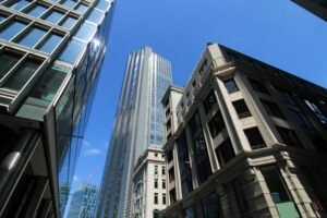 pexels-photo-36920205-36920205 Upward view of London's modern skyscrapers under a clear blue sky.